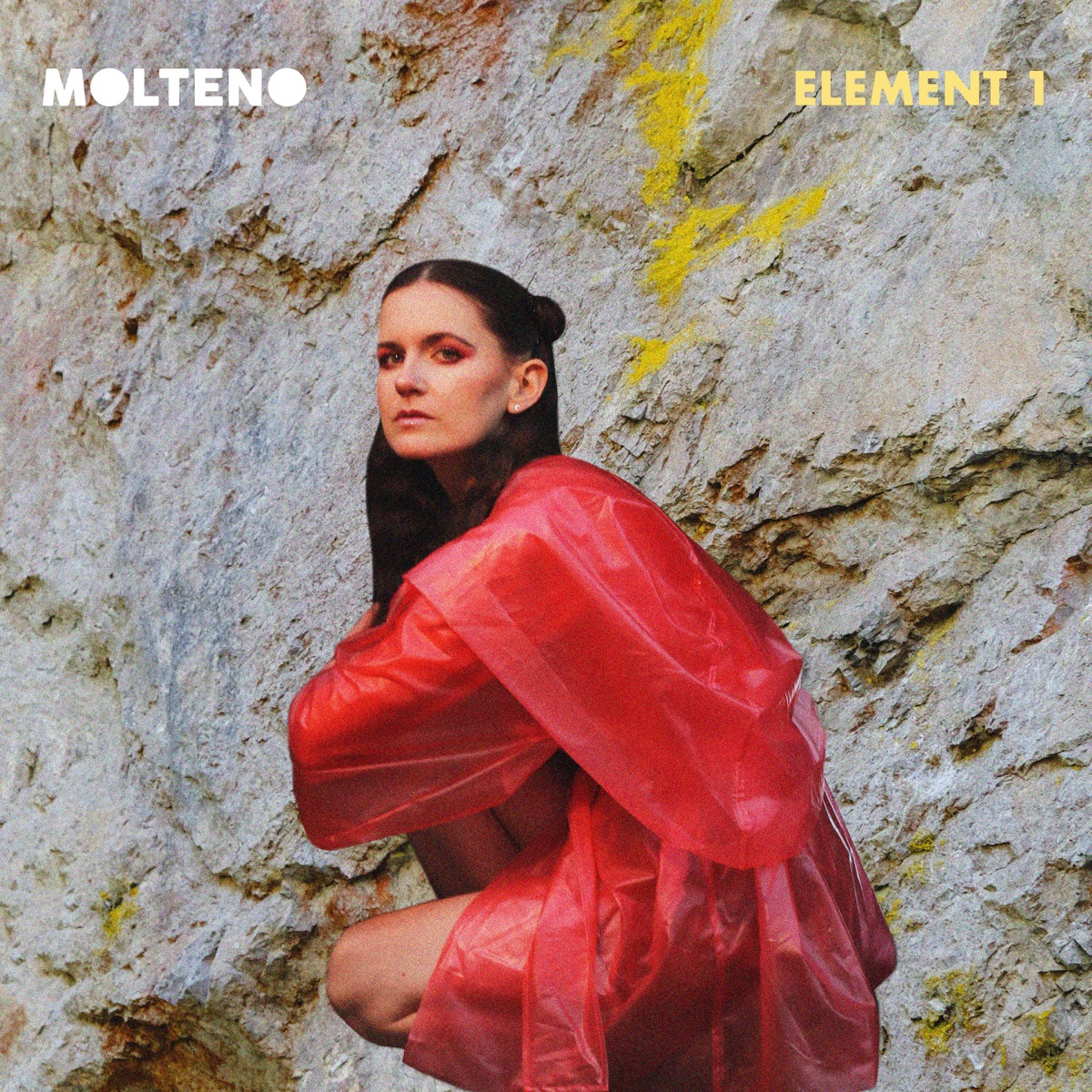 Element 1 artwork: MOLTENO crouched in a red PVC coat against a lichened rock face.